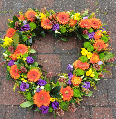 bright open heart - Open heart tribute in bright colours, orange, purple, yellow, green and red.  flowers may vary due to availability.