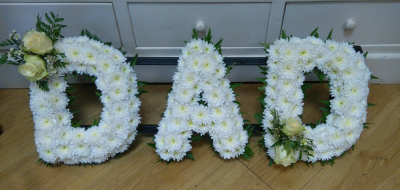 Based Letters - White based letters with a foliage edge and flower and foliage classic sprays in the colour of your choice.