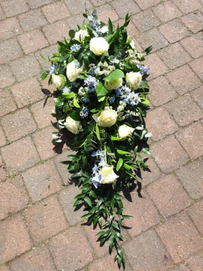 Pale blue and white rose single ended spray - Single ended spray of white roses and a pale blue highlight.