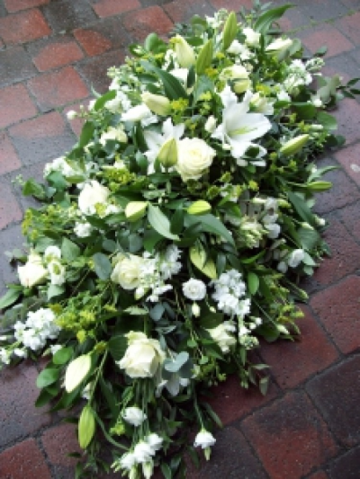 White flower casket spray - Large green and white flower casket spray with seasonal white flowers