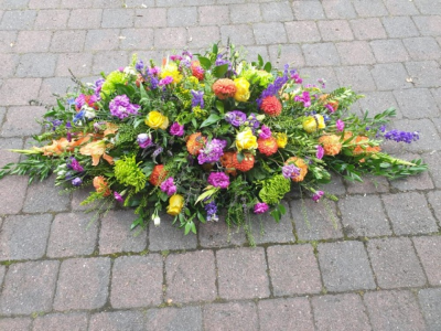 Bright double ended Spray - Brightly coloured flowers in a double ended spray.  A celebration of flowers in a funeral tribute.