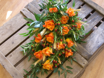 Autumn rose tied funeral sheaf - Orange roses with dried wheat, rosemary and mixed seasonal foliage for an autumnal funeral tribute