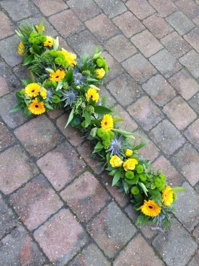 Loose Natural style Cross - Natural cross with yellow and greens plenty of foliage and eryngium thistles.