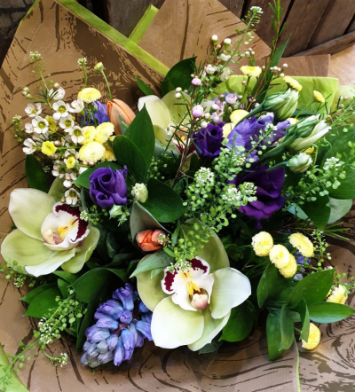 Scented Spring flowers - Short spring flowers hand tied in a posy to include scented available flowers for example, hyacinths, cymbidium orchids, narcissi, waxflower and tulips.